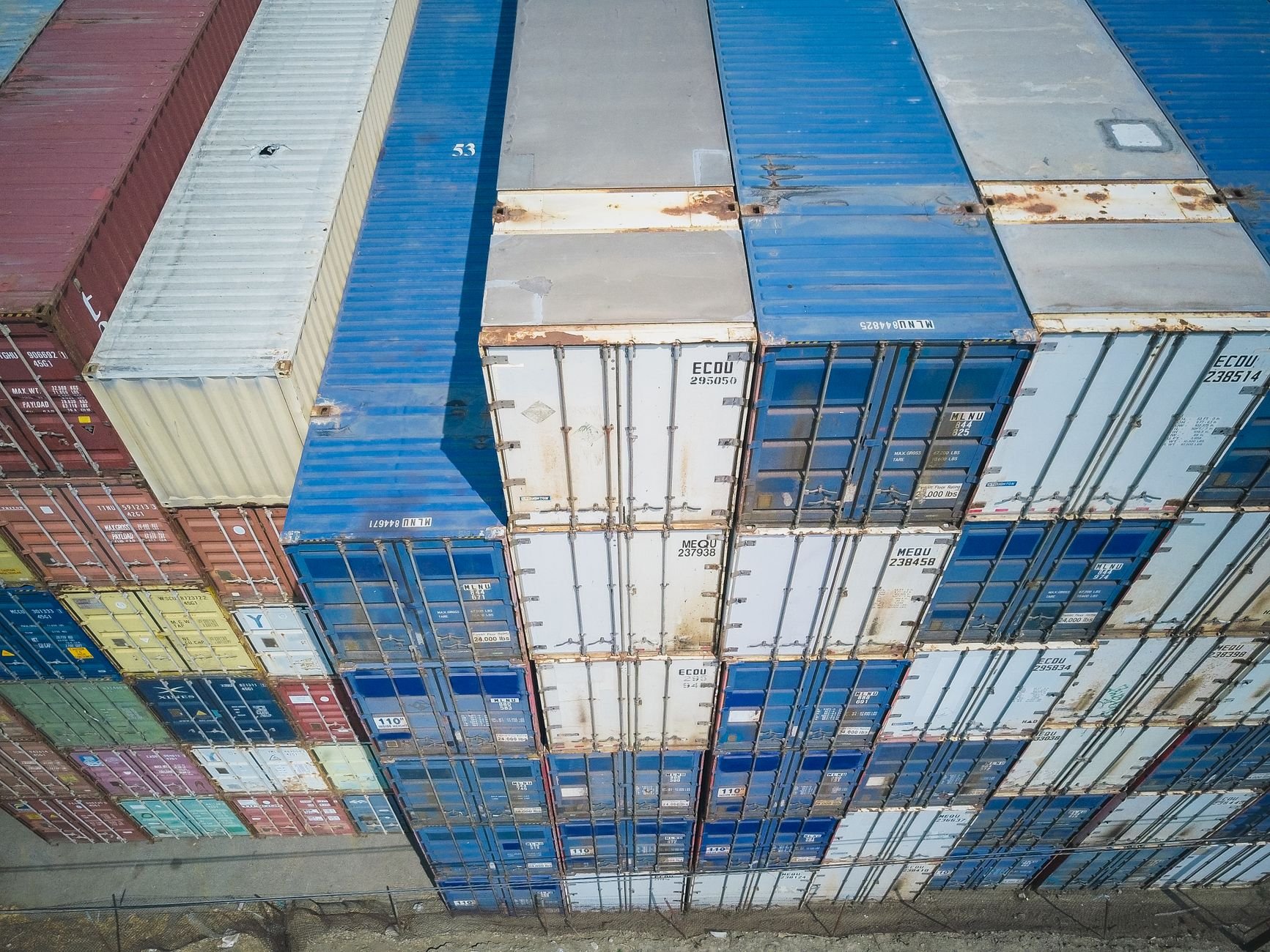Aerial view of colorful stacked cargo containers at a shipping yard
